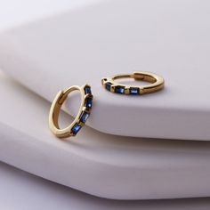 Looking for a September birthday gift?  Our Sapphire Huggie Hoop Earrings in Solid 14K yellow gold make the perfect gift.  These are also available with Ruby or Diamonds in white or rose 14K gold. Arrives gift ready with free shipping. #sapphire #septemberbirthstone #sapphireearrings #sapphirejewelry #huggies #hoopearrings #hoops #earrings #jewelry #lakeforest #chicagojeweler #sparkle #dresstoimpress #backtoschool #fallearrings Bazaar Magazine, September Birthday, Fall Earrings, Hoops Earrings