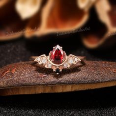 Vampire Garnet Gothic Engagement Ring Solid Gold Bat Wings Moissanite Black Onyx Wedding Ring Halloween Gift for Her Garnet Witchy Jewelry RING DESCRIPTION ✦Engagement Ring ✴Center Stone - Garnet Shape - Pear Cut Size - 4×6mm ✴Side Stones - Black Onyx & Moissanite or Diamond Shape - Round  Cut Weight - 0.044 ct Clarity - SI-VS Color- G-H ✴Band Width - About 1.5mm ✴Ring Metal:  Available in rose gold plated, yellow gold plated, 925 sterling silver, 10k or 14k solid rose, yellow or white gold. MAK Black Ring With Red Stone, Black Diamond Wedding Ring, Black Diamond Wedding Rings, Wings Black, Gothic Engagement Ring, Wedding Ring For Women, Gothic Ring, Witchy Jewelry, Gothic Rings