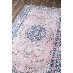 a pink rug with blue accents on the floor