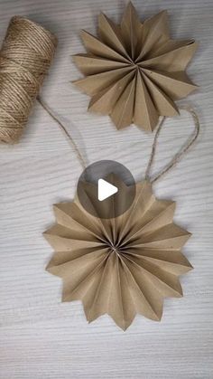 some brown paper flowers and twine on a table