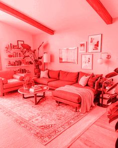 a living room filled with red couches next to a tall wooden beamed ceiling