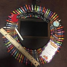 there are many crayons arranged in the shape of a wreath with a ruler