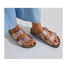 An icon of timeless design and legendary comfort, the Arizona sandal has been defining style since 1973. An electric gold finish transforms the classic look into your favorite be-seen pair, outfitted with tonal buckles to elevate the look. Complete with classic BIRKENSTOCK design elements, like a contoured cork-latex footbed for the ultimate in support. Contoured cork-latex footbed creates custom support with wear Birko-Flor® upper with pearlized shimmer Suede footbed lining helps keep you comfo Birkenstock Madrid Big Buckle, Birkenstock Styles, Birkenstock Outfit, Birkenstock Sandals Arizona, Two Strap Sandals, Skandinavian Fashion, Birkenstock Arizona, Nubuck Leather, Sandal Women