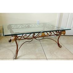 a glass and metal coffee table on tiled floor