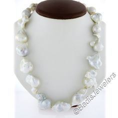 These beautiful baroque freshwater pearls stand our with their large size and create a truly unique looking necklace that is sure to make a bold statement. The beautiful clasp is custom made and designed to look similar to a baroque pearl and is crafted from solid 14k yellow gold. Absolutely gorgeous piece and so much fun to wear. Enjoy :) --Stone(s): -- (19) Genuine Cultured Freshwater Pearls - Baroque Shape - White Color & beautiful Colorful Pink, Gray, Green Overtones - Graduated from 14mm to