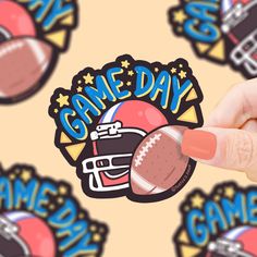 a hand holding a football and helmet sticker on top of a game day background