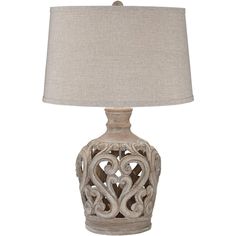 a white lamp with a beige shade on it's base and a light bulb in the shape of an ornamental design