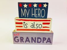 a wooden sign that says my hero is also in front of an american flag and stars