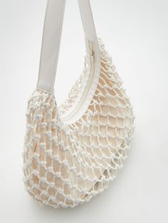 an image of a handbag on a white background that looks like it has been made out of yarn