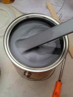 a paint can with a knife sticking out of it