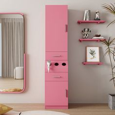 a pink cabinet in the corner of a room next to a mirror and potted plant