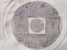 a white towel with a circular design in the center on it's back side