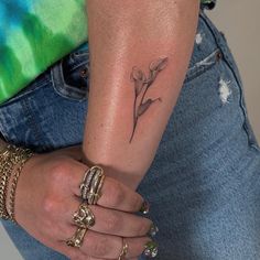 a woman with a flower tattoo on her arm