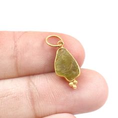 Raw Peridot Charm, 18k Gold Charm, Handmade Charm Pendant, Gemstone Charm, Raw Peridot Gold Charm, Birthstone Charm Pendant, Dainty Charm  Material  Metal = 18k Gold Gemstone = Raw Peridot  Stone Color = Green Raw Stone Size = 7X12 mm Stone Shape = Raw  Stone Creation = Natural Total Charm weight = 740 Milligram  Charm Bail Size = 4.5 mm Product Making = Handmade  Thank You Visiting My Shop. Gold Peridot Gemstone Jewelry, Gold Peridot Jewelry With Gemstone, Gold Pendant Gemstones For Jewelry Making, Gold Pendant Gemstone For May Birthstone, Gift Yellow Gold Peridot Gemstones, Raw Peridot, Peridot Stone, Handmade Charms, Birthstone Charms