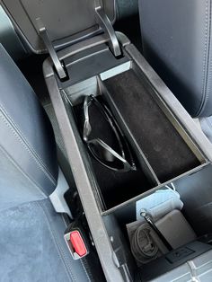 a pair of glasses sitting in the back seat of a car with its lid open