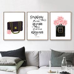 three framed art prints on the wall above a white couch with pillows and a coffee table