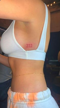 a woman's stomach with the number 22 on her left side and two small numbers on her right side