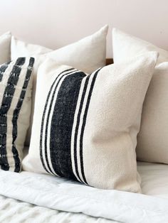 black and white striped pillows on a bed