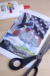 a pair of scissors sitting on top of a cutting board next to an american flag