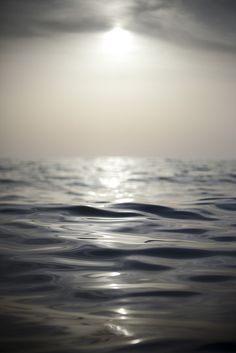 the sun shines brightly over the ocean as it reflects on the water's surface