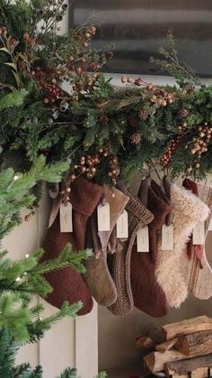 stockings hanging from a fireplace with christmas decorations