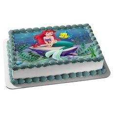 the little mermaid cake is decorated with blue icing