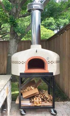 an outdoor pizza oven with wood in it