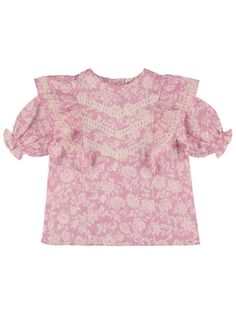 Ruffled details . Puff sleeves. Lace trim. All over print placement may vary Pink Puff Sleeve Cotton Blouse, Cotton Ruffle Sleeve Tops With Floral Print, Cotton Tops With Ruffle Sleeves And Floral Print, Cotton Tops With Floral Print And Ruffle Sleeves, Cotton Top With Floral Print And Ruffle Sleeves, Cute Ruffled Puff Sleeve Tops, Cotton Blouse With Floral Print And Ruffle Sleeves, Cotton Ruffle Puff Sleeve Blouse, Cotton Tops With Floral Print And Ruffled Collar