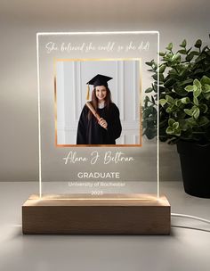 a clear acrylic plaque with an image of a graduate on the front and side