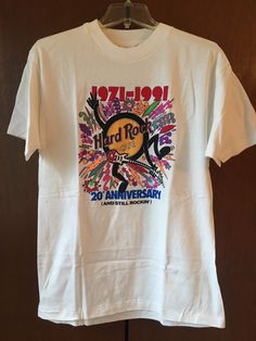 a white t - shirt with an image of the band hard rock 20th anniversary on it