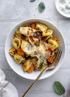 a white bowl filled with pasta and cheese