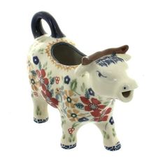 a ceramic bull planter with flowers on it's body and horns sticking out