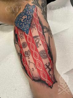 a man's arm with an american flag tattoo on it