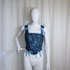 This delicate corset was created for a modern-day fairy princess to help to evoke the magical spirit of your own personal fairy tale. This corset is made from second hand store jeans and cotton flowery shirt. We seek to reduce textile waste and pollution by creating something new from  unusable clothes that end up in a landfill. This corset features: -Corset has back lacing (~2 m of satin ribbon) -The bows on the shoulders can be re-tied to fit perfectly -Corset is fully lined with flower cotton Blue Overbust Corset Dress For Costume Party, Blue Corset Dress With Fitted Bodice, Blue Overbust Corset For Costume Party, Blue Fitted Corset For Costume Party, Fairycore Fitted Corset For Costume, Blue Corset With Boned Bodice, Blue Overbust Corset For Party, Fairycore Fitted Overbust Corset Dress, Blue Overbust Corset With Boned Bodice