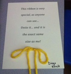 a piece of paper that has some type of yellow string attached to it with a thread