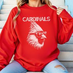 Cardinals Mascot Crewneck Sweatshirt Cardinal Shirt Cardinal Sweatshirt Cardinal Mascot Shirt Cardinal Crewneck College Merch Gameday Shirt Ideal for any situation, a unisex heavy blend crewneck sweatshirt is pure comfort. These garments are made from polyester and cotton. This combination helps designs come out looking fresh and beautiful. The collar is ribbed knit, so it retains its shape even after washing. There are no itchy side seams on these sweaters.  .: Made with a medium-heavy fabric b Casual Long Sleeve Fan Merchandise Tops, Casual Long Sleeve Tops For Fan Merchandise, Red Casual Sweatshirt With Screen Print, Casual Pre-shrunk Sweatshirt For Fan Merchandise, Casual Pre-shrunk Sweatshirt For Fans, Casual Crew Neck Sweatshirt For Fan Gear, Casual Red Sweatshirt With Team Name, Casual Game Day Top With Crew Neck, Casual Crew Neck Tops For Game Day