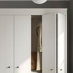 an open closet with clothes hanging in it