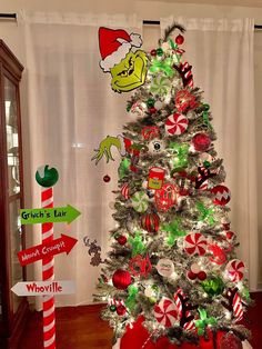 a christmas tree decorated with grin's hat and candy canes