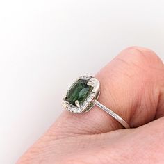 A vivid chrome tourmaline looks exquisite in this elegant ring with a diamond halo. A statement ring design perfect for an eye catching engagement or anniversary. This ring also makes a beautiful October birthstone ring for your loved ones. This ring is made with solid 14K Gold and natural Earth mined SI / G-H diamonds. As listed, this ring is ready to ship. If you're interested in purchasing this setting with a different center stone please message us! Elegant Green Sapphire Ring With Halo Setting, Elegant Tourmaline Jewelry With Halo Setting, Elegant Halo Ring For May Birthstone, Tourmaline Rings With Halo Setting For Wedding, Elegant Halo Ring With May Birthstone, Elegant May Birthstone Halo Ring, October Birthstone Ring, Chrome Tourmaline, October Birthstone Rings