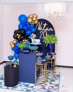 a table topped with balloons and cake on top of a checkered tile floor next to a wall