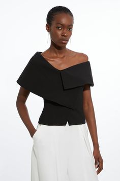 Elevate Your Evening Looks In Our Top, With A Fitted Silhouette, An Asymmetric Collar, And Off Shoulder, Bardot Sleeves. Style It With Tailored Trousers Or Jeans And Strappy Heels For An Elevated Evening Look, Then With Jeans And Loafers For A More Casual Approach. Compact Stretch Asymmetric Collar Tailored Top High Quality Stretch Fabric Flattering Fitted Silhouette Unique Asymmetric Neckline Bardot Sleeves Stylish Top, Soft Dramatic Jeans, Structured Clothing, Assymetrical Top Outfits, Black Top And Jeans Outfit, Asymmetrical Top Outfit, Asymmetrical Outfit, Petite Business Casual, Bride Jumpsuit