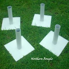 four white paper tubes are placed on the ground in order to make them stand out