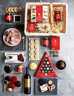 an assortment of food and condiments laid out on a counter top with wine