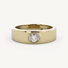 a yellow gold ring with a round diamond in the center, on a white background