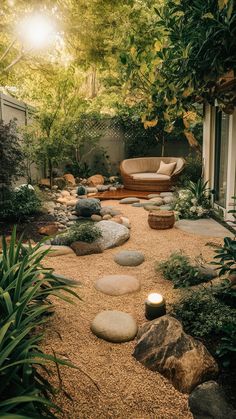 a garden with rocks, gravel and plants in the foreground is lit by candles