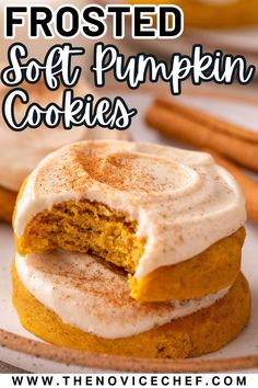 frosted soft pumpkin cookies on a plate with cinnamon sticks in the background and text overlay that reads, frosted soft pumpkin cookies