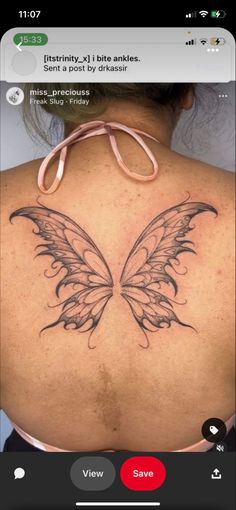 the back of a woman's shoulder with a butterfly tattoo on it