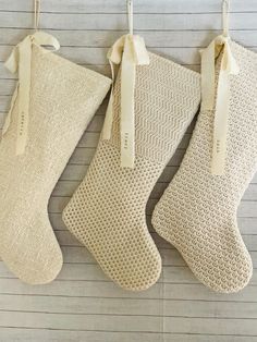 three christmas stockings hanging on the wall