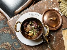 a bowl of stew on a table with a spoon