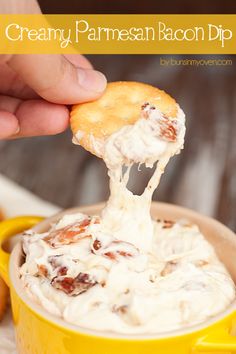 a person dipping some food into a yellow cup with the words creamy, parmesan bacon dip on it